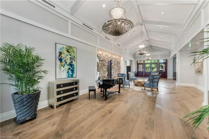 Community lobby with beam ceiling, high vaulted ceiling, and recessed lighting