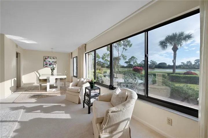 Living room with baseboards and light colored carpet