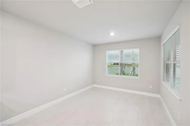 Unfurnished room with baseboards and recessed lighting