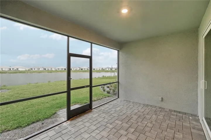 Unfurnished sunroom with a water view and a residential view