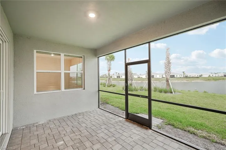 Unfurnished sunroom with a water view and a residential view