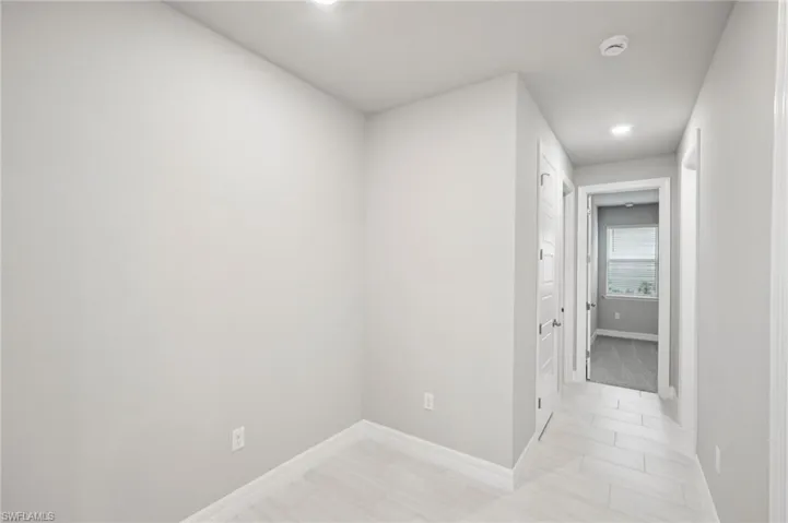 Hallway featuring baseboards and recessed lighting
