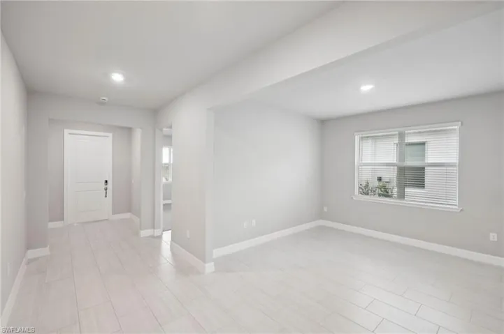Empty room featuring plenty of natural light, baseboards, and recessed lighting