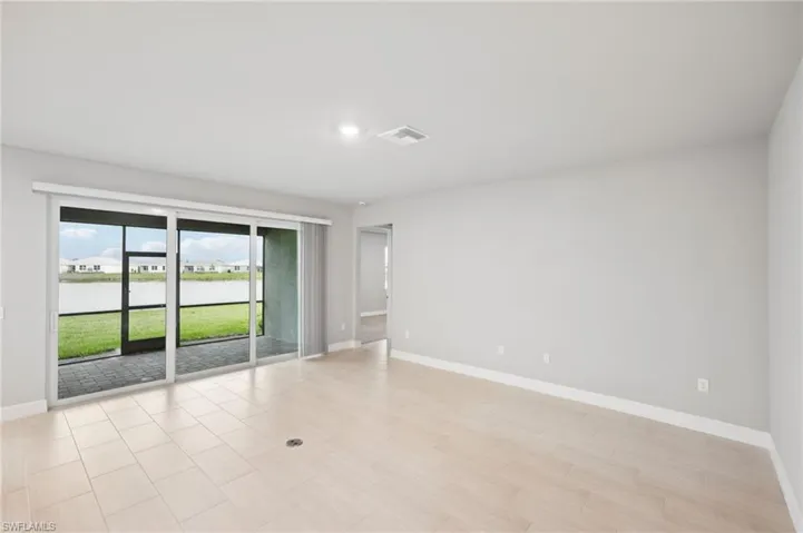 Empty room featuring baseboards and recessed lighting