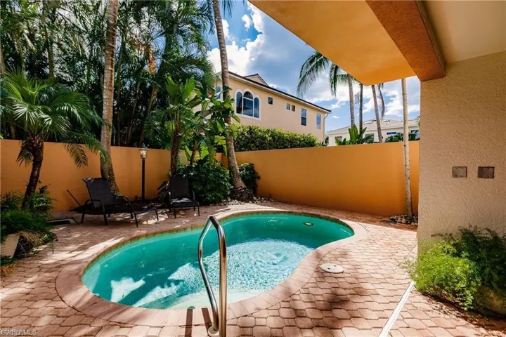 View of swimming pool with a patio area and a fenced backyard