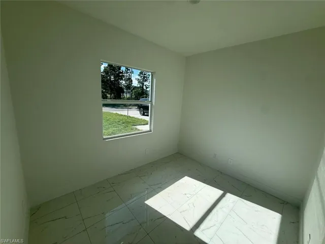 Unfurnished room featuring light marble finish flooring