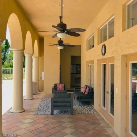 View of patio with french doors, ceiling fan, and an outdoor living space