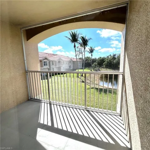 Balcony featuring a residential view and a water view
