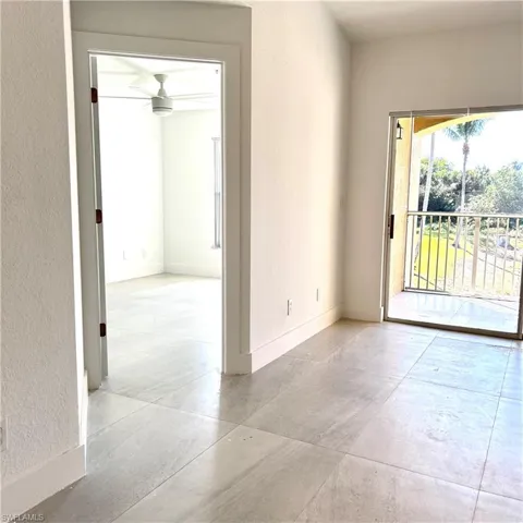 Spare room with baseboards and a textured wall
