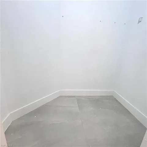 Unfurnished room featuring baseboards