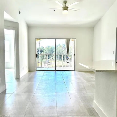 Empty room featuring a ceiling fan and baseboards