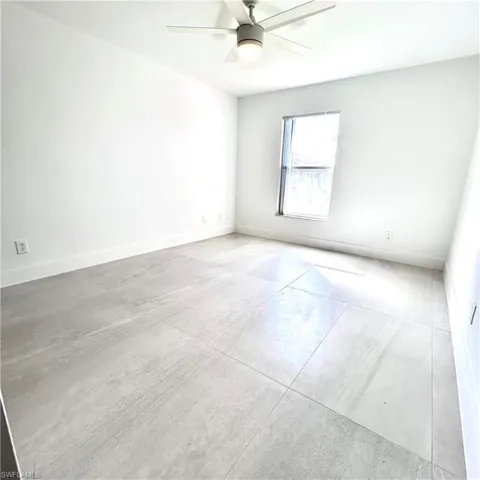 Unfurnished room featuring baseboards and a ceiling fan
