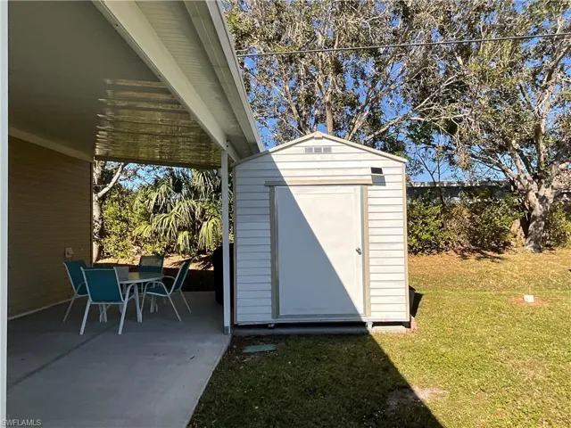 View of outbuilding featuring a yard
