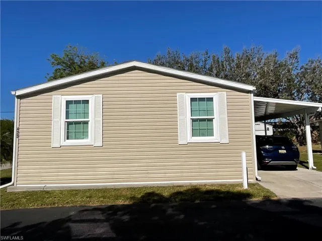 View of side of home featuring a carport