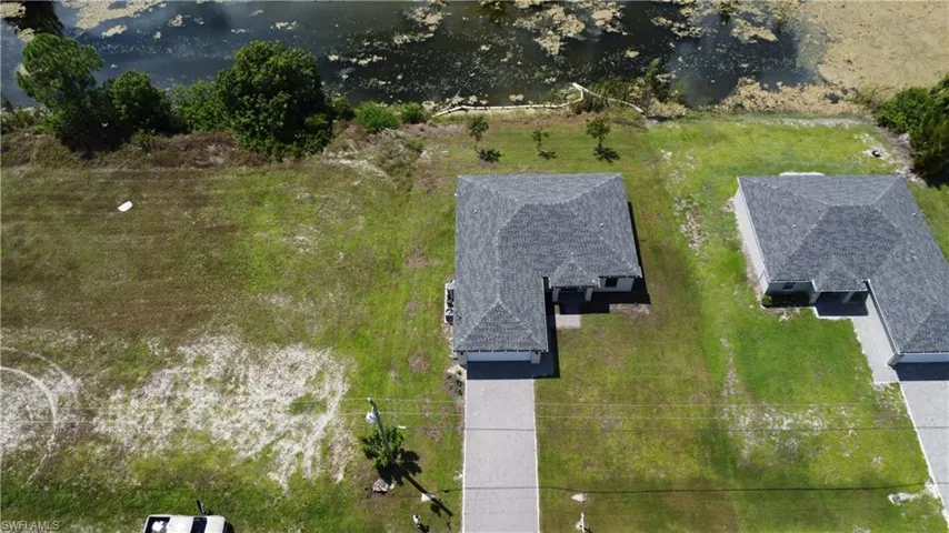 Single-story residence with a gray shingle roof, attached garage, and concrete driveway