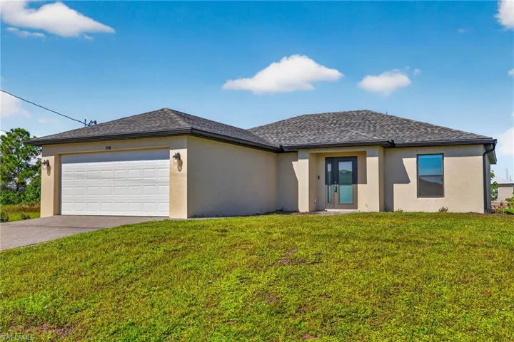 Single-story residence featuring a two-car garage, asphalt shingle roof, and a covered entryway
