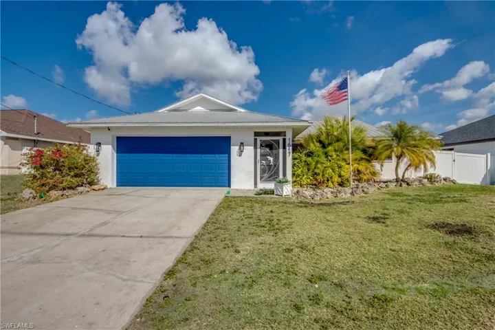 Ranch-style house with stucco siding, driveway, and an attached garage