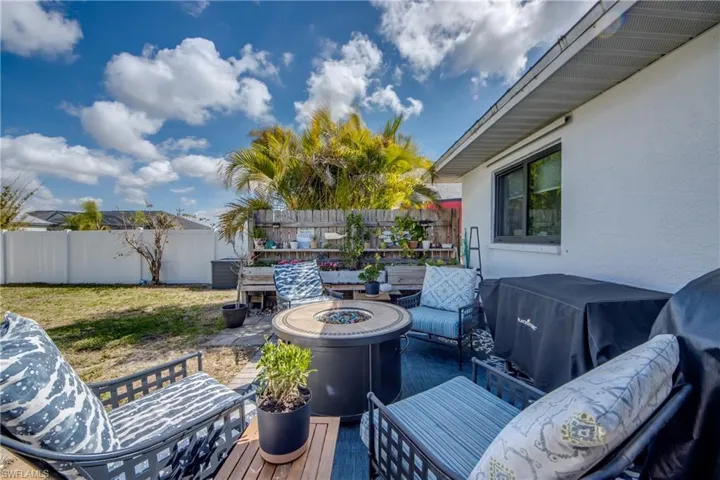 Fenced backyard with an outdoor living space with a fire pit and a patio area