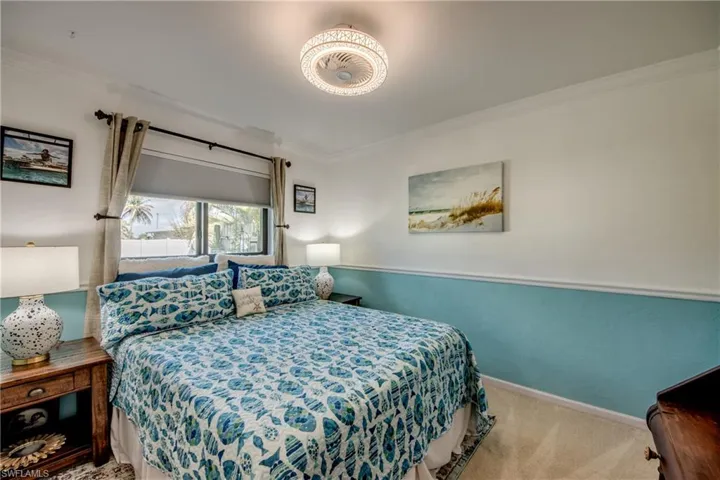Carpeted bedroom featuring ornamental molding and baseboards