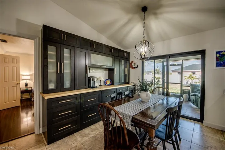 Dining space with lofted ceiling and hanging lights