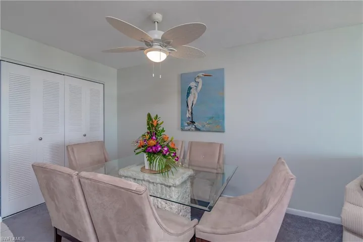 Dining room featuring dark carpet and ceiling fan