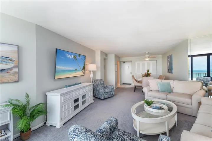 Living room featuring carpet flooring and ceiling fan