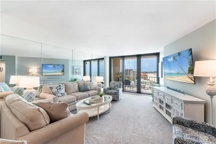 Carpeted living room with floor to ceiling windows