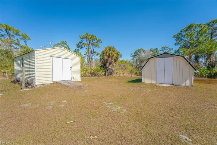 View of green lawn featuring a shed