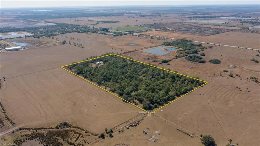 Aerial view of sparsely populated area featuring property boundaries highlighted
