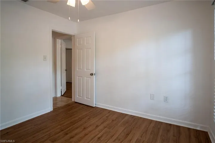 Spare room featuring ceiling fan and wood-type flooring