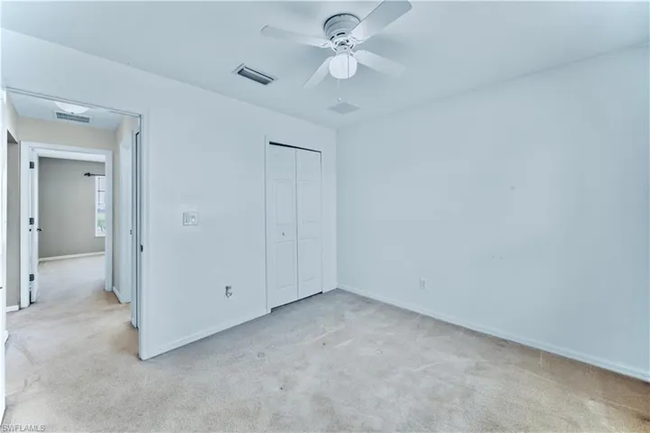 Unfurnished bedroom featuring light carpet, a closet, baseboards, and visible vents