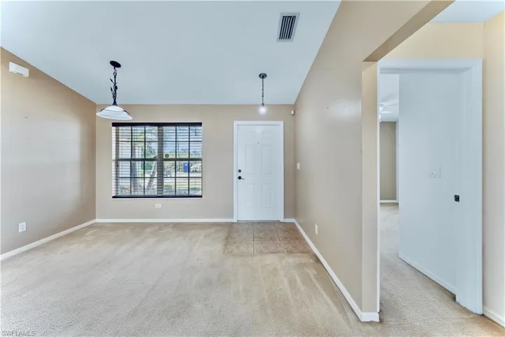Entrance foyer with visible vents, light colored carpet, and baseboards