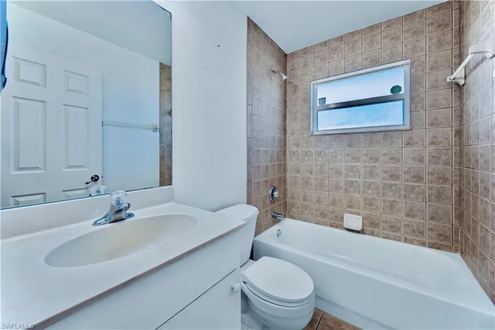 Full bathroom featuring toilet, vanity, and shower / bathtub combination
