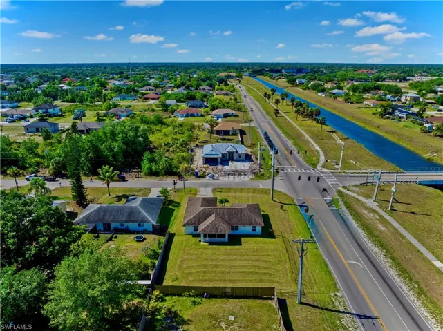 Drone / aerial view with a water view and a residential view