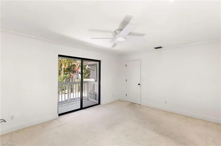 Unfurnished room with ceiling fan, ornamental molding, and light colored carpet