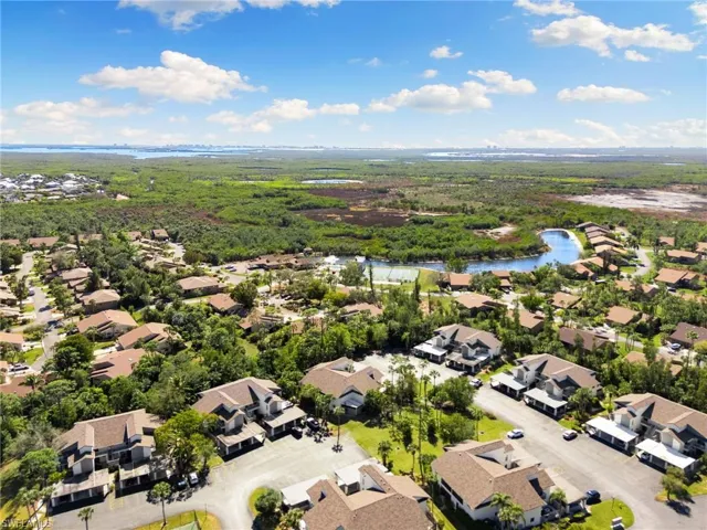 Aerial perspective of suburban area featuring a nearby body of water