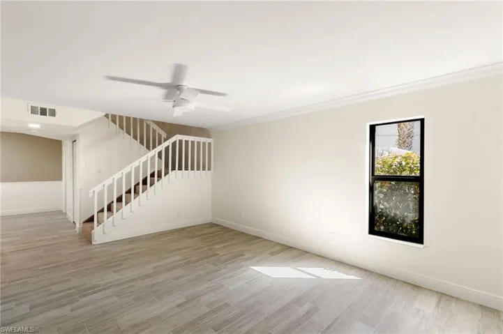 Unfurnished living room featuring light wood finished floors and a ceiling fan