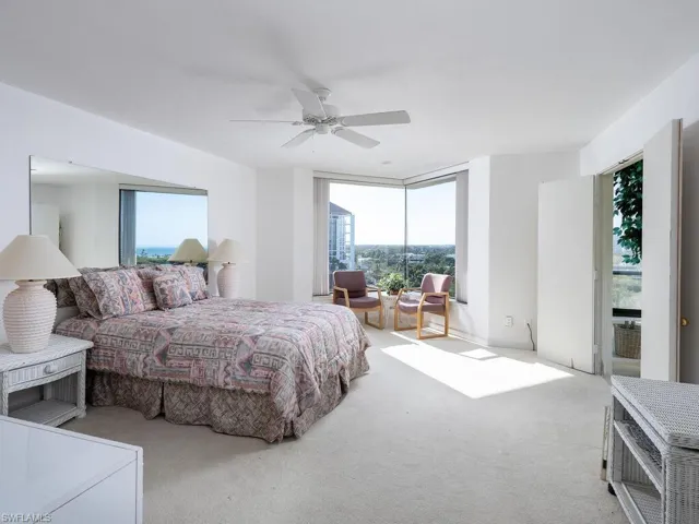 Carpeted bedroom featuring ceiling fan