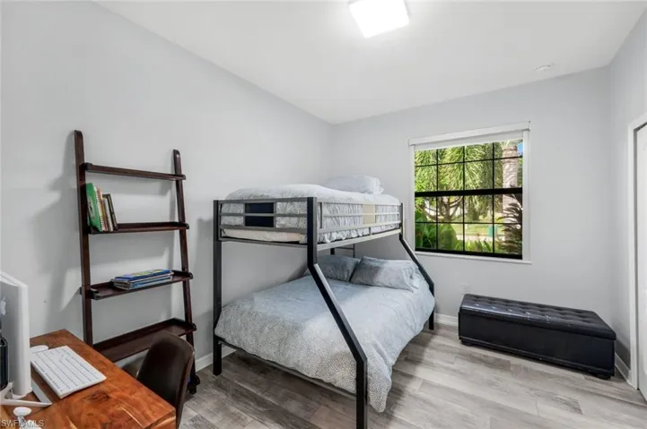Bedroom with light wood-style floors and baseboards
