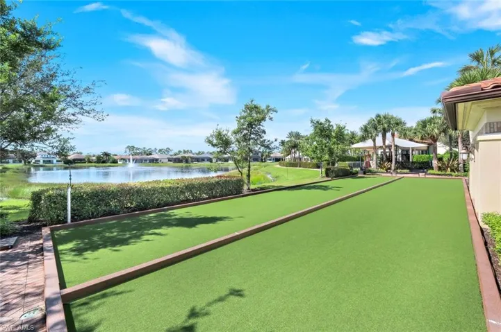 View of community featuring a water view and a game area