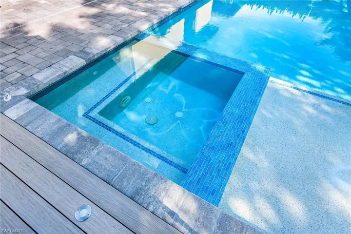 View of pool with a pool with connected hot tub