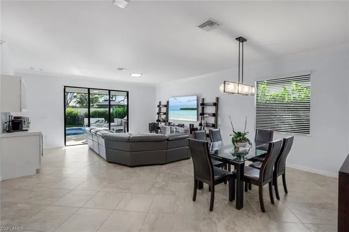 Dining room featuring crown molding and light tile patterned flooring