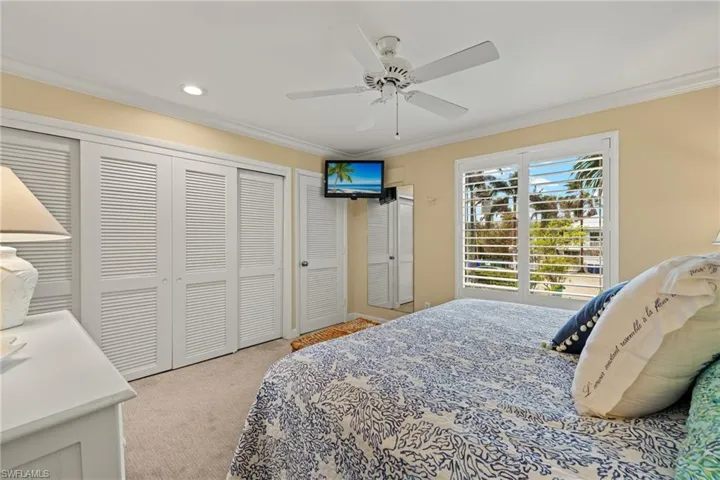 Bedroom featuring crown molding, light colored carpet, a closet, ceiling fan, and recessed lighting