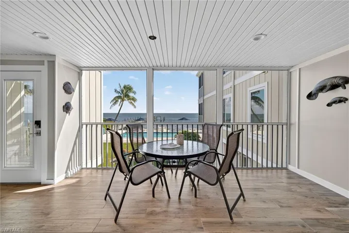 Sunroom / solarium with a water view and healthy amount of natural light