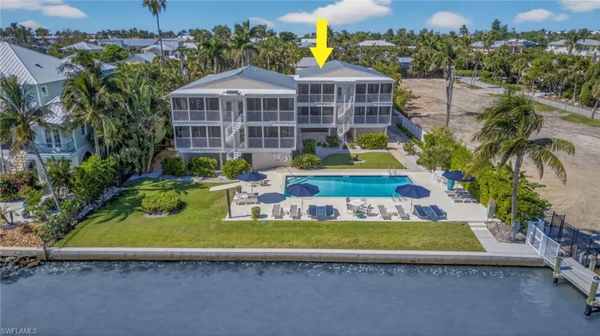 Community pool featuring a patio area, a yard, and stairway