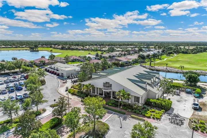 The property features a large building with a distinctive roofline, surrounded by mature trees and manicured landscaping