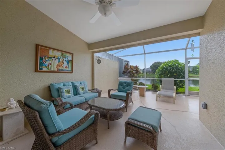 View of patio / terrace with ceiling fan, a lanai, outdoor lounge area, and a water view