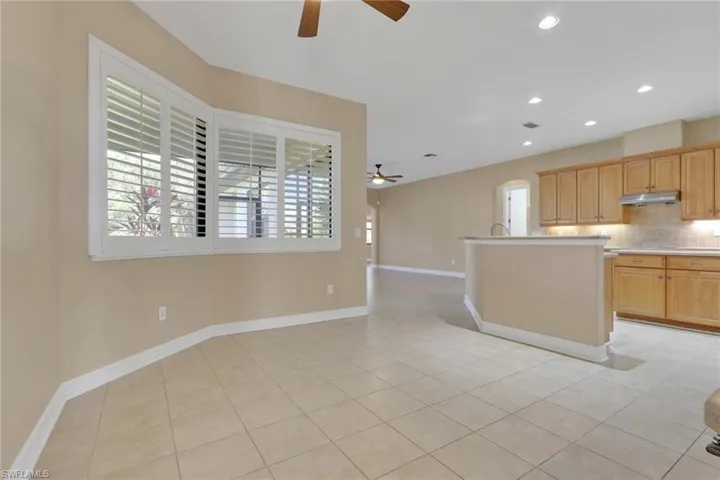 Kitchen with recessed lighting, light countertops, decorative backsplash, ceiling fan, and light tile patterned floors