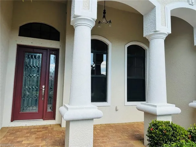 Entrance to property with stucco siding