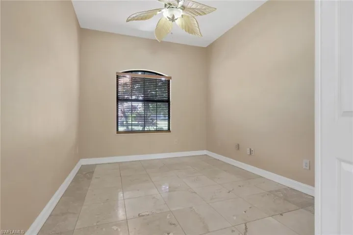 Spare room featuring baseboards and a ceiling fan
